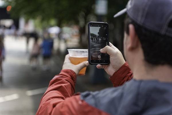 Man uploading picture of beer during Cheerwine Festival